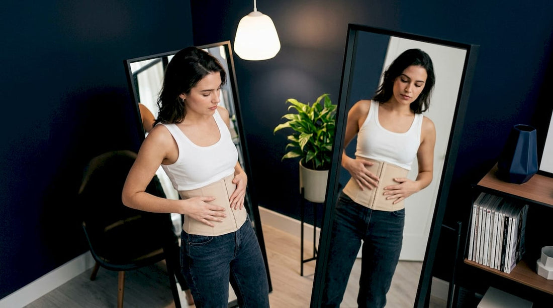 Woman adjusting waist cincher in bedroom mirror