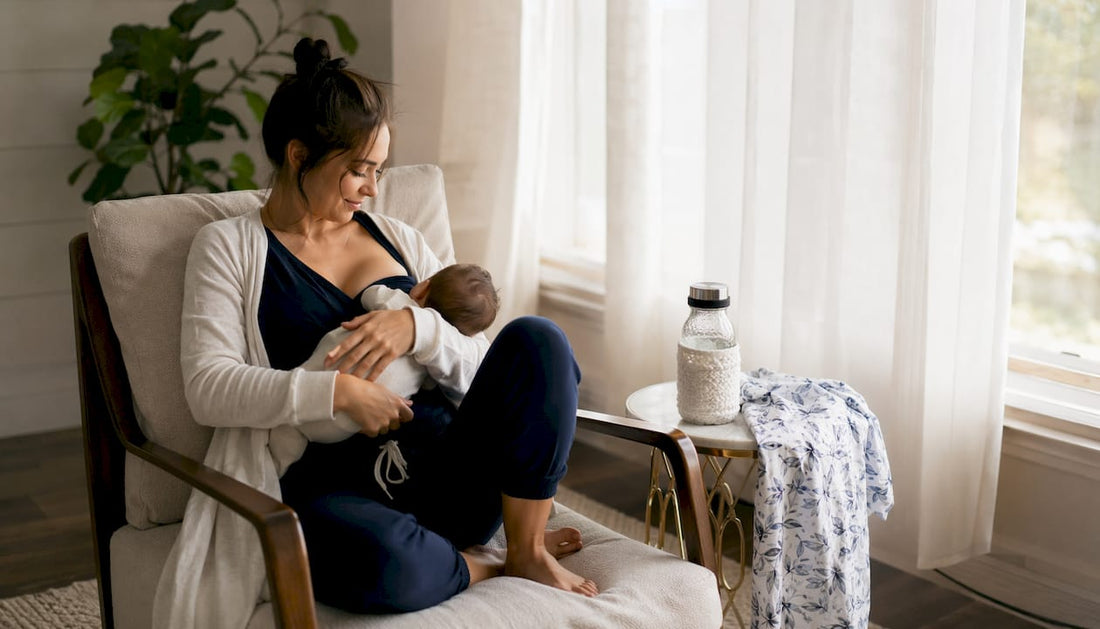 New mom wearing layered nursing outfit indoors